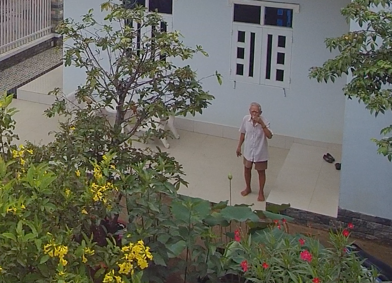 The maternal grandpa watching fly cam from above at home in My Tho city